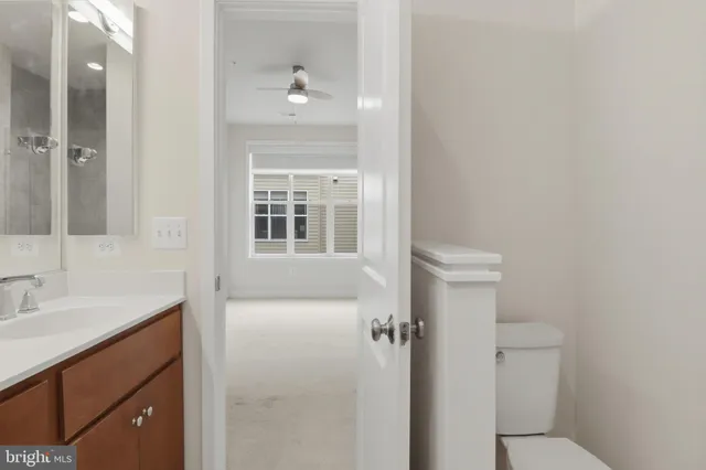a bathroom with a sink and mirror with toilet