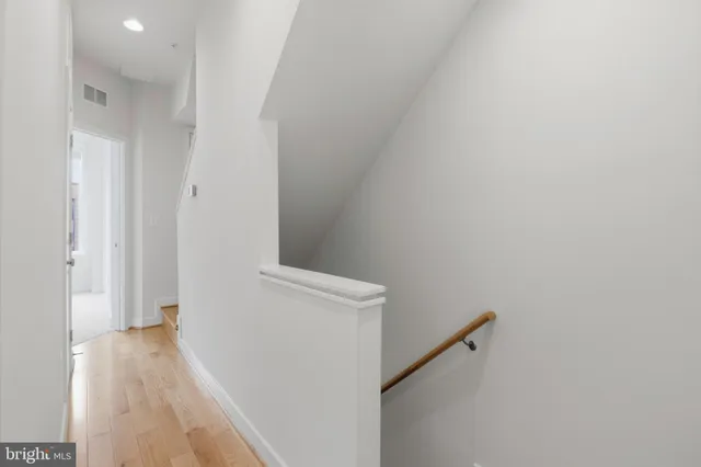 a view of hallway with wooden floor