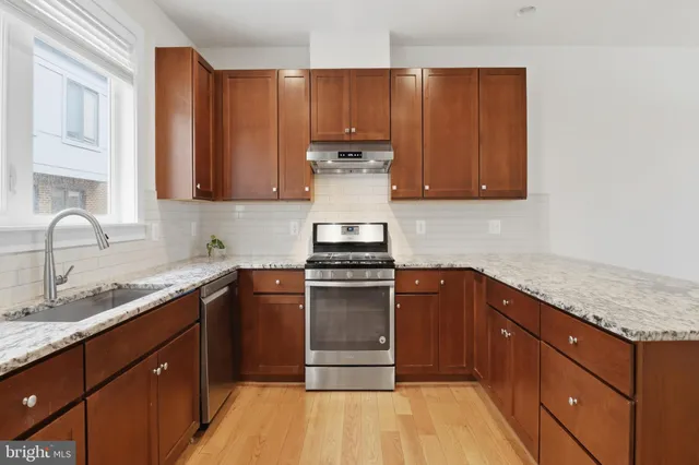 a kitchen with a sink stove and cabinets