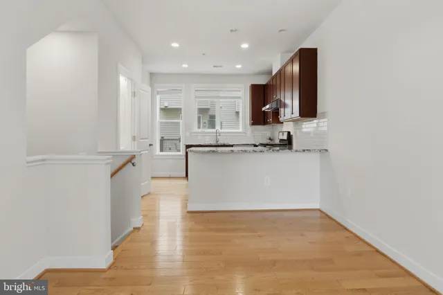 a large kitchen with stainless steel appliances granite countertop a sink and a stove