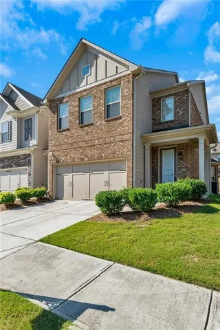 a front view of a house with a yard and garage