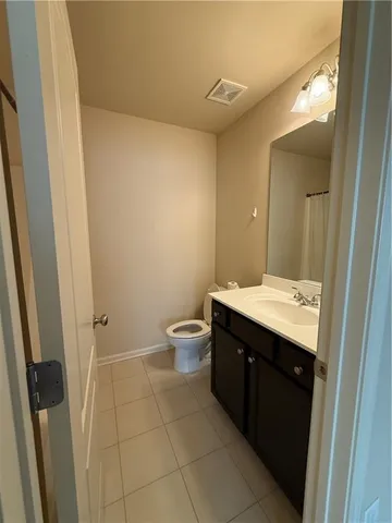 a spacious bathroom with a double vanity sink toilet and shower