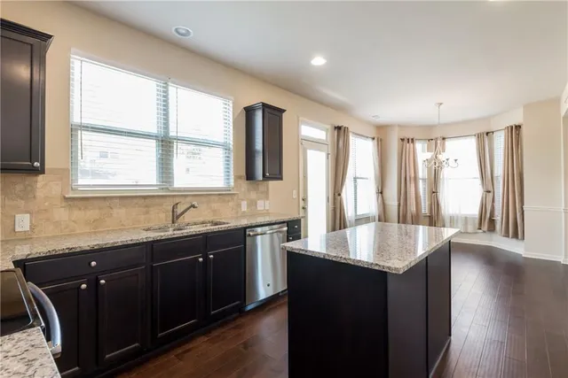 a kitchen with granite countertop a sink and a window