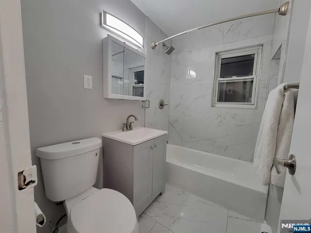 a bathroom with a sink mirror vanity and toilet
