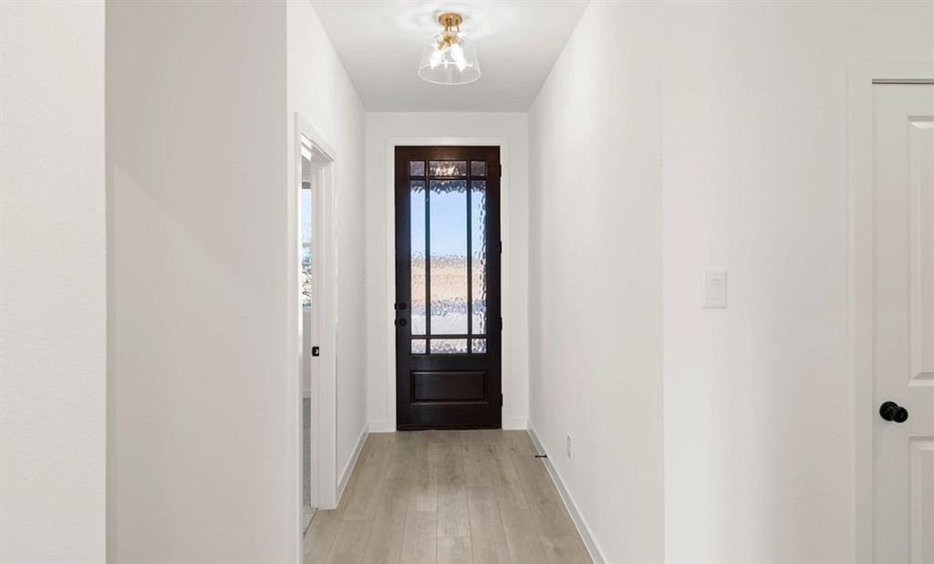 1901 Boston Way Princeton, TX 75407 - Photo 5 of 15 a view of a hallway with wooden floor and a entryway