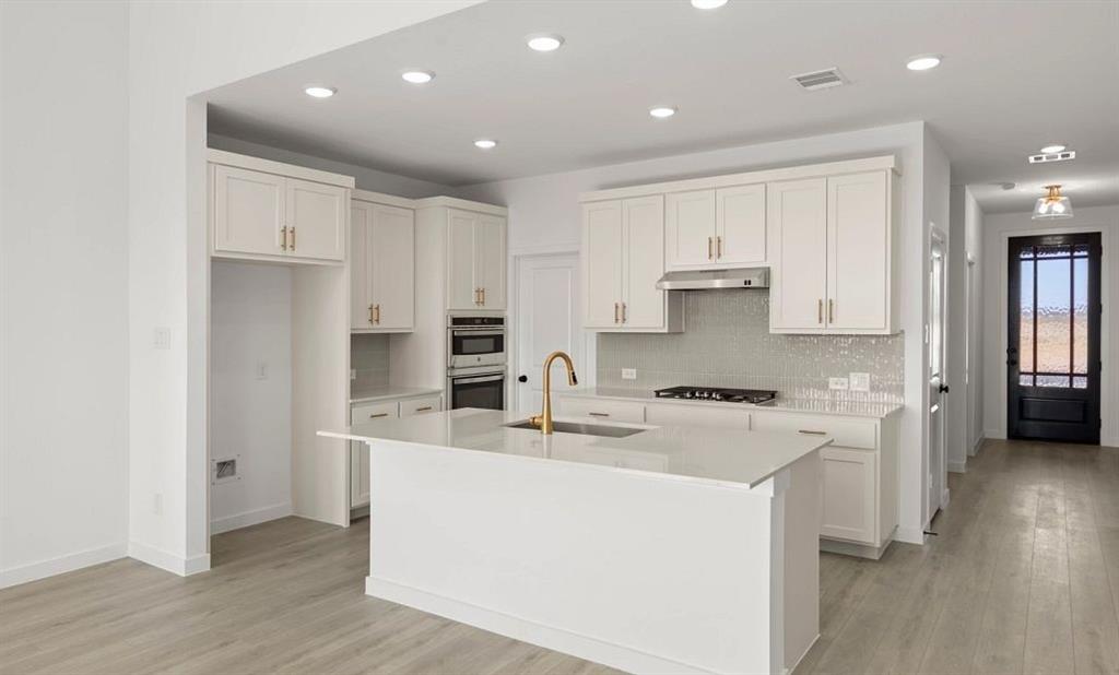 1901 Boston Way Princeton, TX 75407 - Photo 6 of 15 a kitchen with a sink a stove a refrigerator and white cabinets