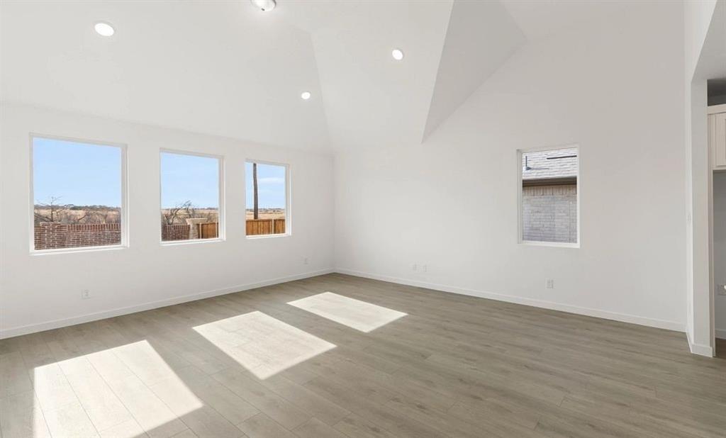 1901 Boston Way Princeton, TX 75407 - Photo 7 of 15 an empty room with wooden floor and windows