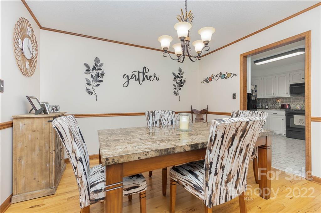 4414 Hunter Rhyne Road Lincolnton, NC 28092 - Photo 11 of 35 a view of a dining room with furniture a chandelier and wooden floor