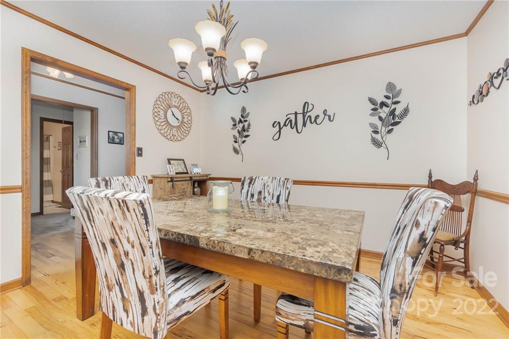 4414 Hunter Rhyne Road Lincolnton, NC 28092 - Photo 12 of 35 a view of a dining room with furniture and chandelier