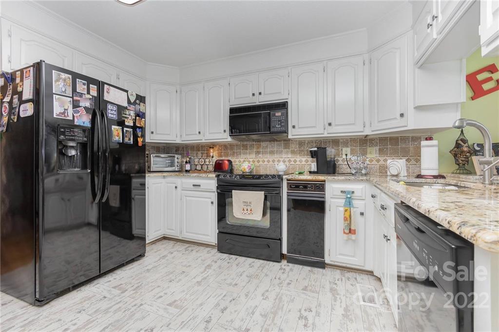4414 Hunter Rhyne Road Lincolnton, NC 28092 - Photo 13 of 35 a kitchen with stainless steel appliances granite countertop a refrigerator a stove and a sink