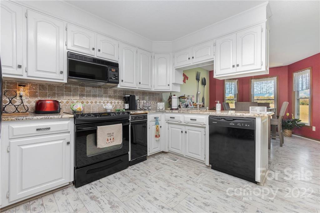 4414 Hunter Rhyne Road Lincolnton, NC 28092 - Photo 14 of 35 a kitchen with a sink stove top oven and cabinets