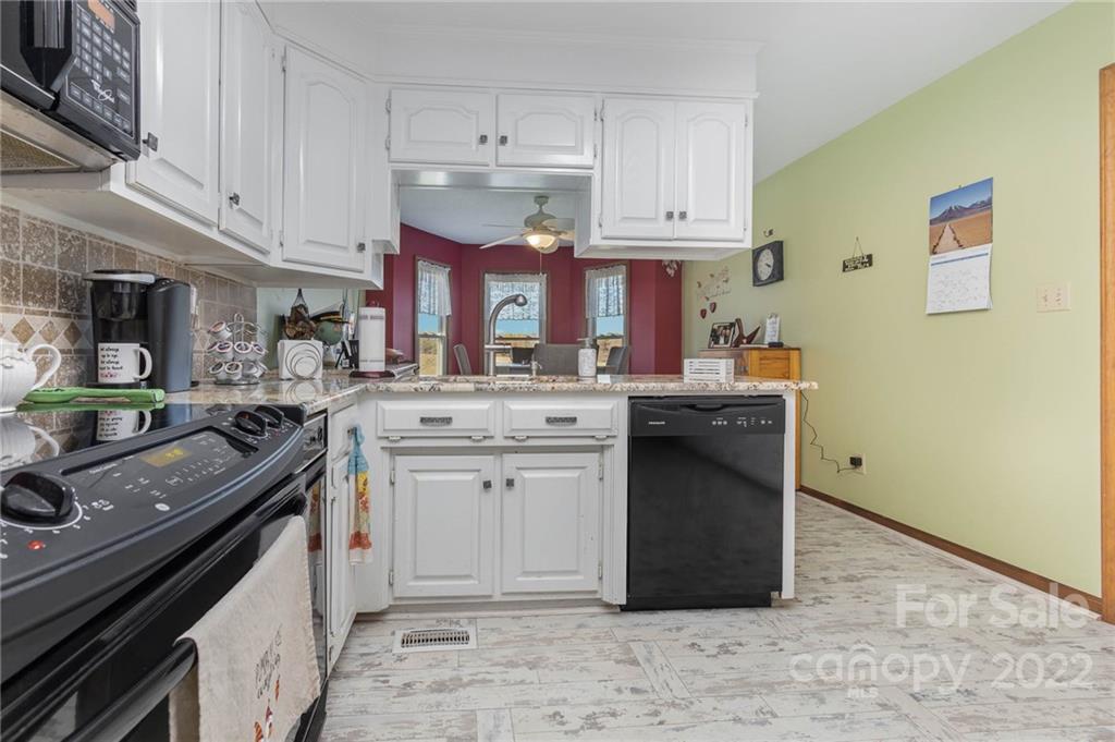 4414 Hunter Rhyne Road Lincolnton, NC 28092 - Photo 16 of 35 a kitchen with stainless steel appliances granite countertop a sink stove and cabinets