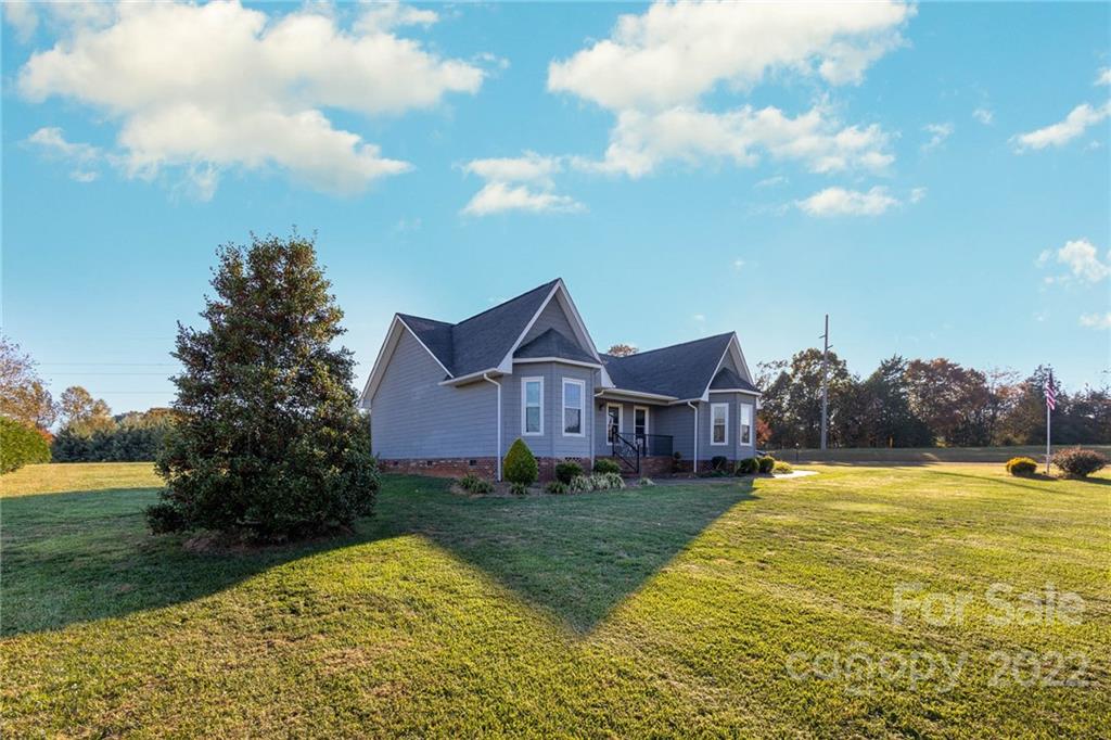 4414 Hunter Rhyne Road Lincolnton, NC 28092 - Photo 2 of 35 a view of a house with a big yard and large trees