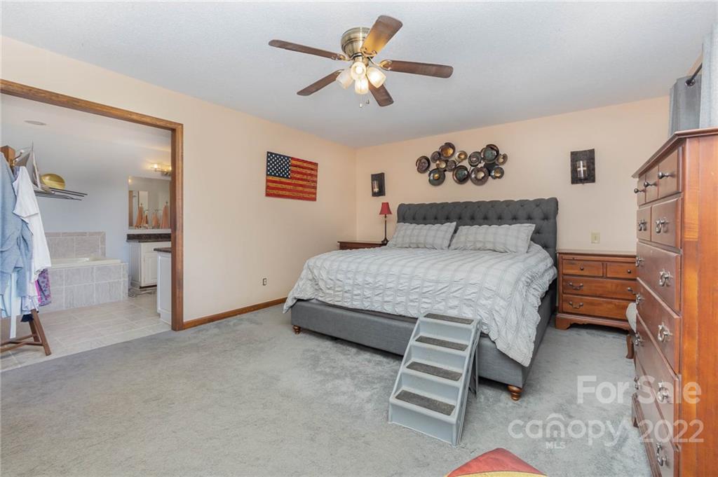4414 Hunter Rhyne Road Lincolnton, NC 28092 - Photo 22 of 35 a bedroom with a bed and a chandelier