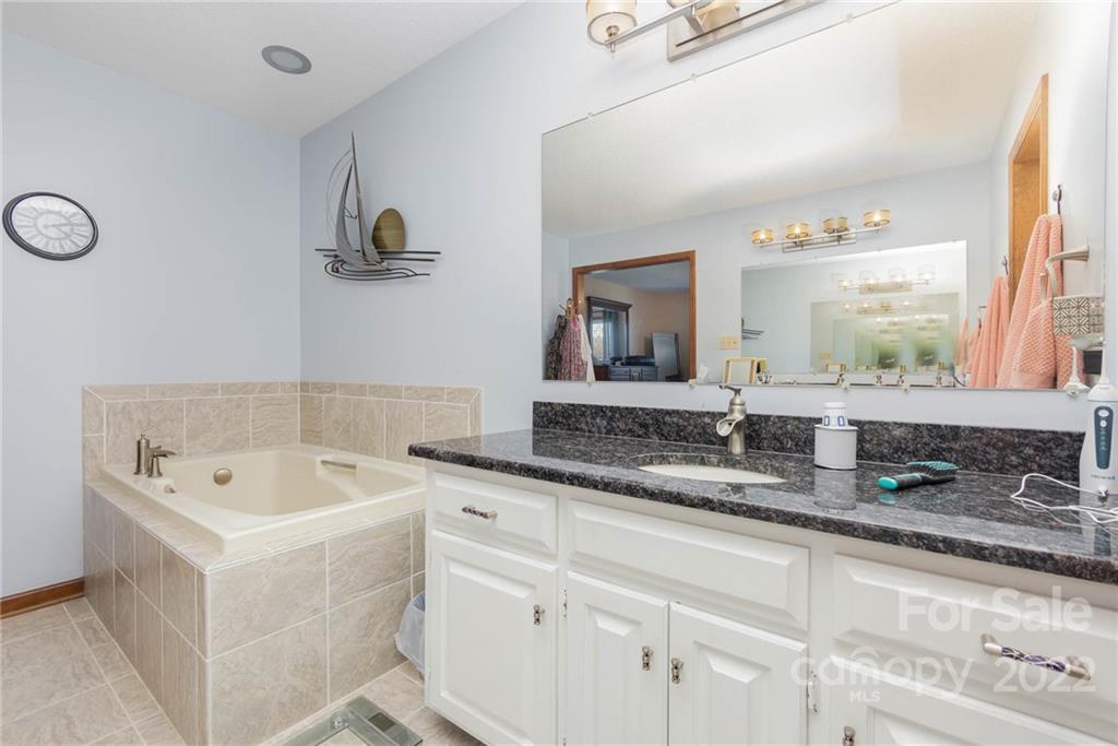 4414 Hunter Rhyne Road Lincolnton, NC 28092 - Photo 23 of 35 a bathroom with a tub sink and mirror
