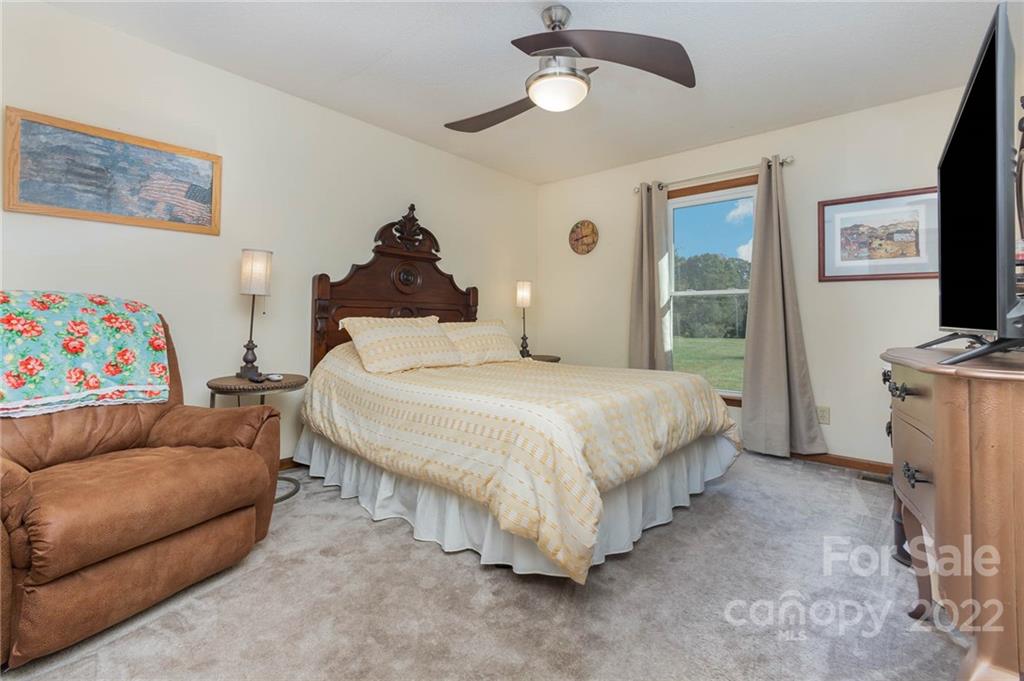 4414 Hunter Rhyne Road Lincolnton, NC 28092 - Photo 27 of 35 a spacious bedroom with a bed and a couch