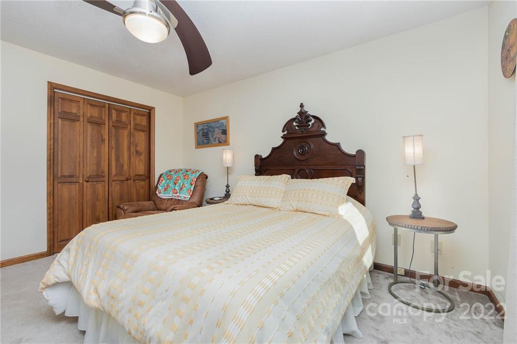 4414 Hunter Rhyne Road Lincolnton, NC 28092 - Photo 28 of 35 a bedroom with a bed and a chandelier