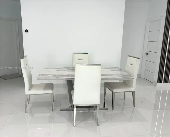 a utility room with a table and chairs