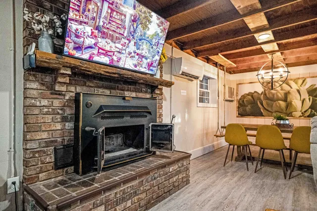 a large bedroom with bed and wooden floor