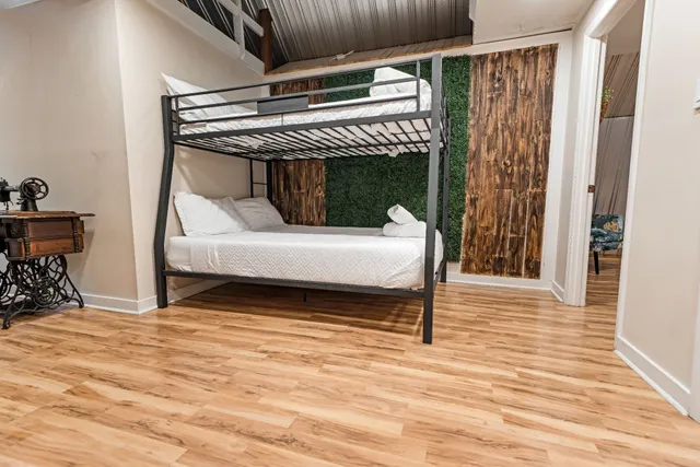 a view of a backyard with a slide trees and wooden fence