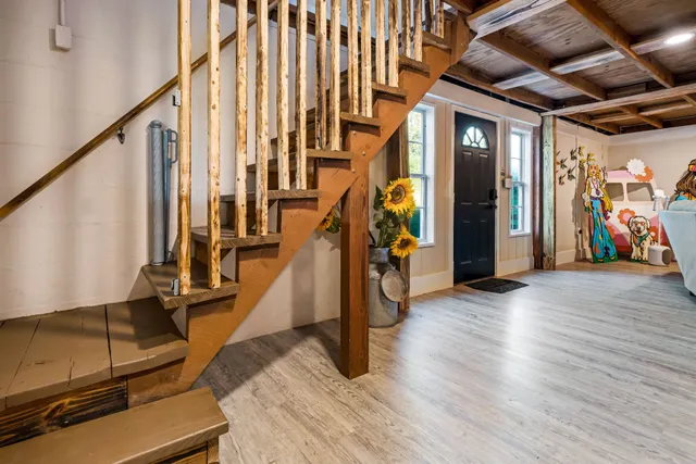 a living room with a couch and a ceiling fan