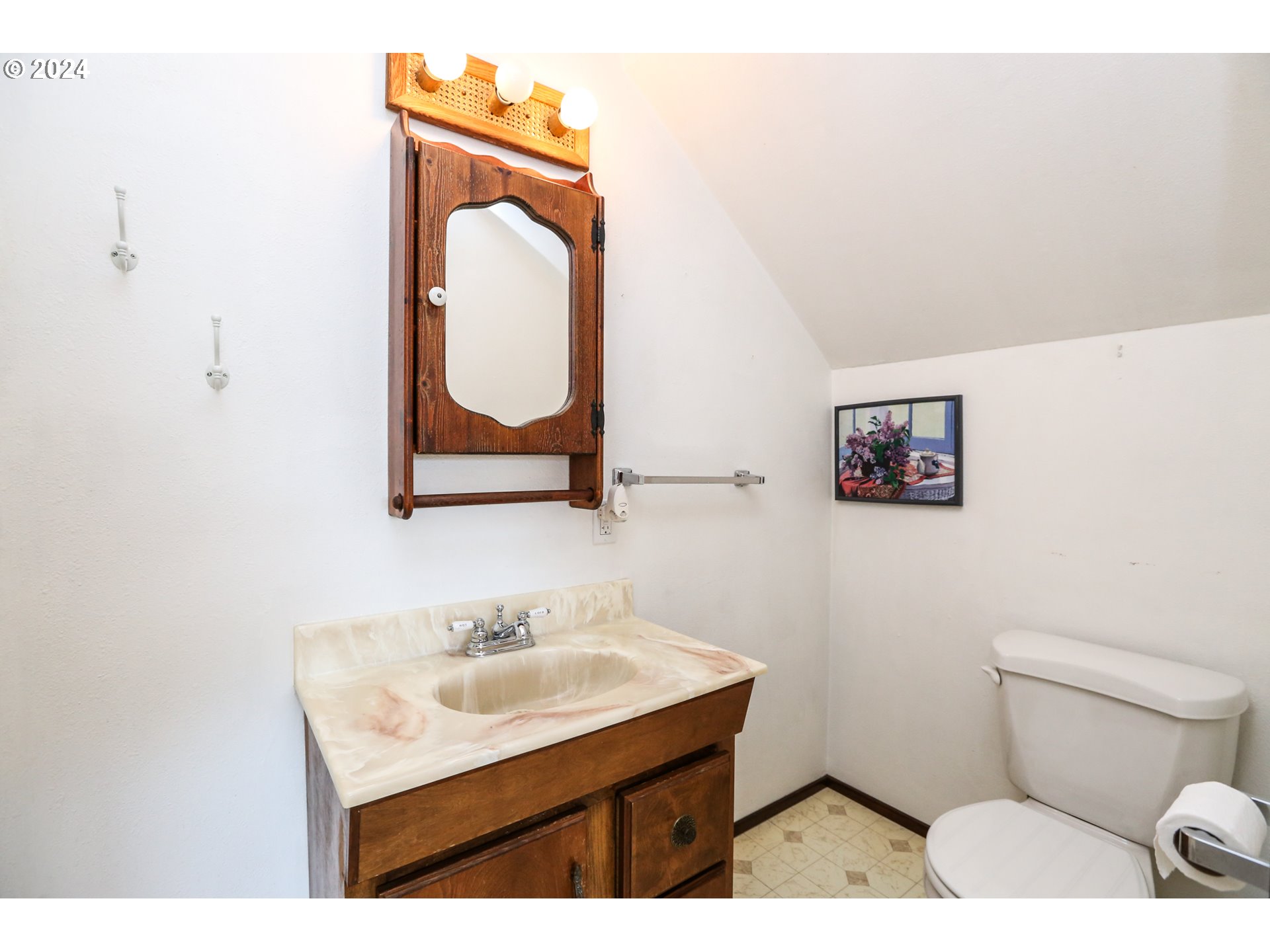 431 65th Street Springfield, OR 97478 - Photo 23 of 32 a bathroom with a sink mirror vanity and toilet
