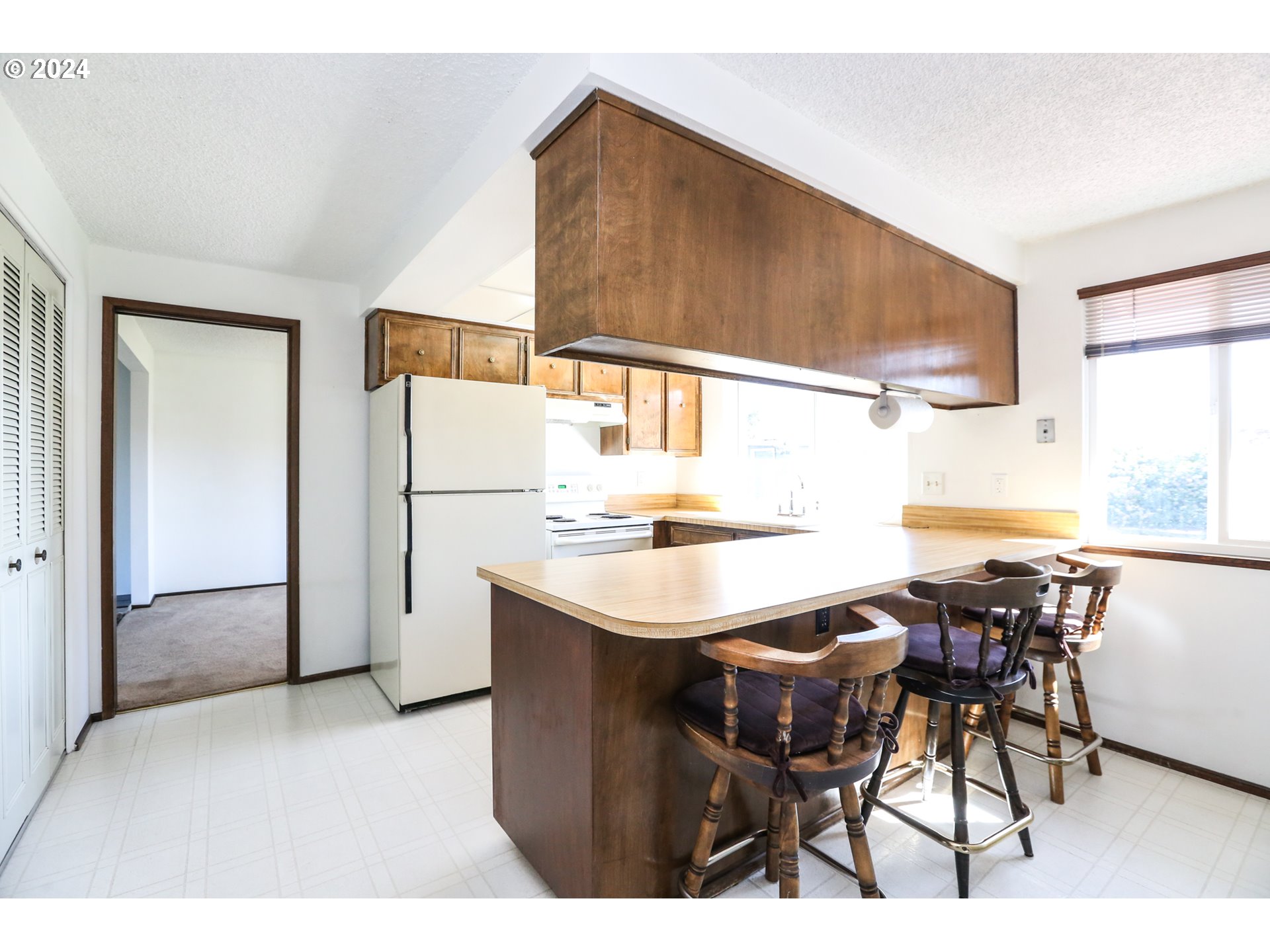 431 65th Street Springfield, OR 97478 - Photo 10 of 32 a kitchen with stainless steel appliances kitchen island granite countertop a table chairs and a refrigerator