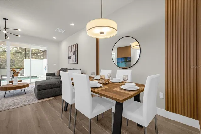 a living room with furniture and a mirror