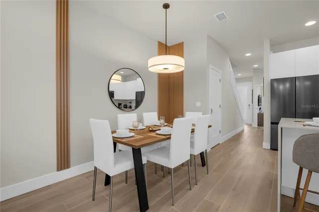 a view of a dining room with furniture and wooden floor