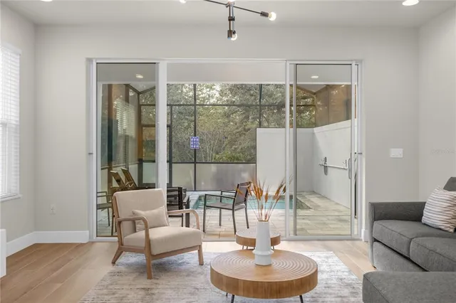 a living room with furniture and a glass door