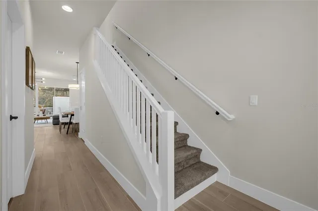 a view of entryway and hall with wooden floor