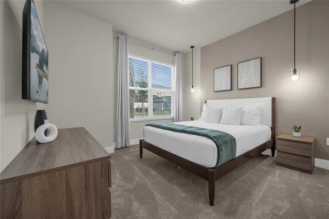 a bedroom with a bed and a lamp