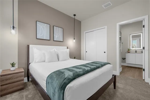 a bedroom with a bed and a flat screen tv