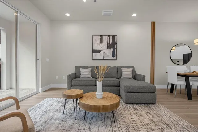 a living room with furniture and a wooden floor
