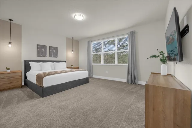 a bedroom with a bed and a night stand