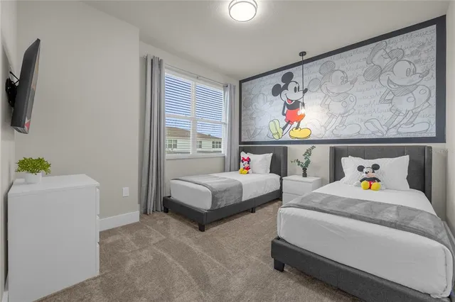 a bedroom with two bed and painting on the wall