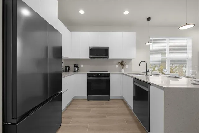 a kitchen with a sink stove and refrigerator