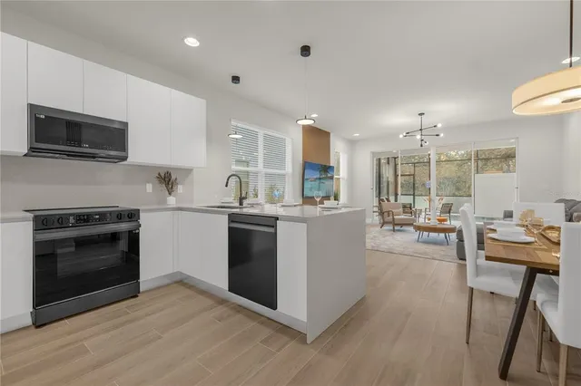 a kitchen with a sink cabinets and stainless steel appliances