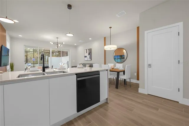 a kitchen with a sink and chairs