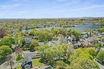 a view of a chair and table in backyard of the house