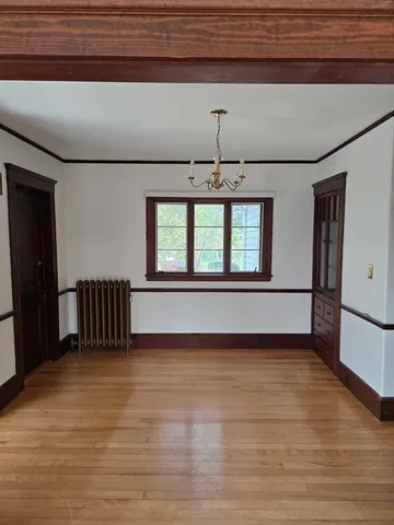 a view of a livingroom with a ceiling fan and window