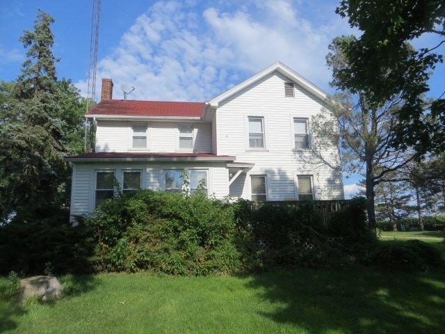 30702 North 1700th Road East Odell, IL 61313 - Photo 1 of 32 a view of a white house with a yard and plants