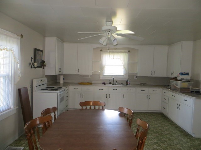 30702 North 1700th Road East Odell, IL 61313 - Photo 28 of 32 a kitchen with a stove a sink a refrigerator and cabinets