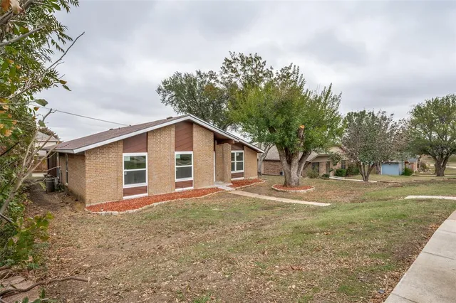 a front view of house with yard and trees