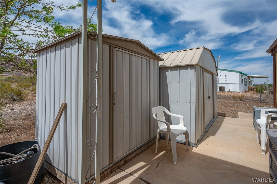 2465 Egar Road Golden Valley, AZ 86413 - Photo 54 of 98 The property includes two outdoor storage sheds with metal siding and a concrete patio area