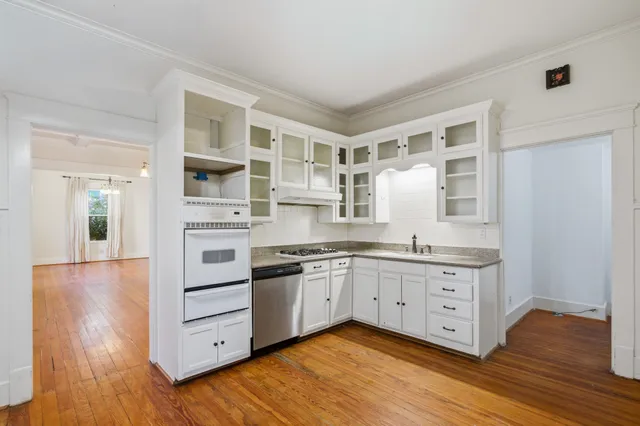 a kitchen with stainless steel appliances granite countertop a stove and cabinets