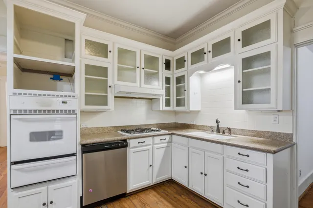 a kitchen with stainless steel appliances granite countertop a stove and a sink