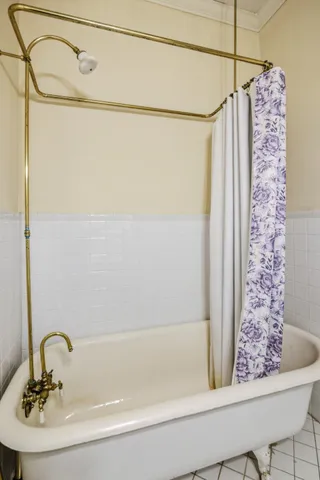 a bathroom with a shower curtain and a sink