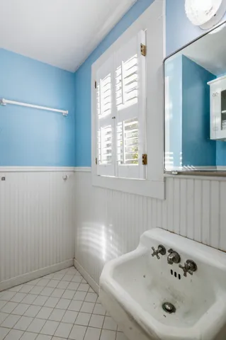 a bathroom with a sink and a window