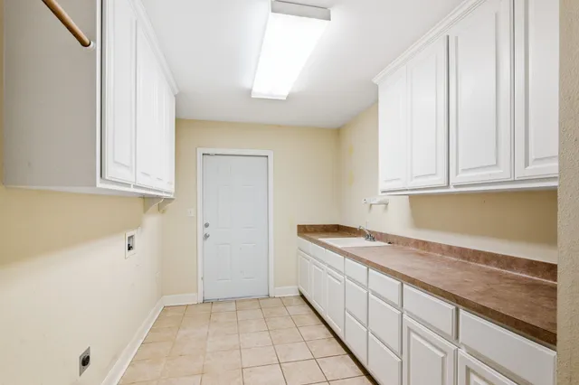 a kitchen with granite countertop white cabinets and sink